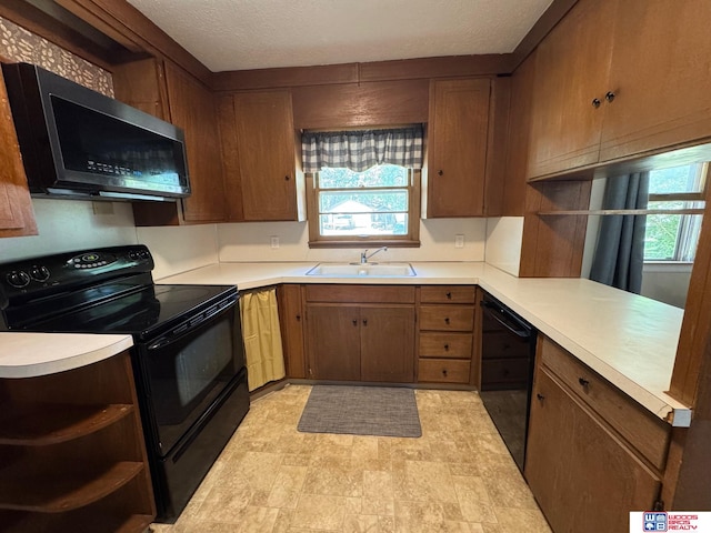 1241 Bessie St, Goehner, NE 68364 - kitchen with black appliances, a sink, open shelves, light countertops, and a textured ceiling
