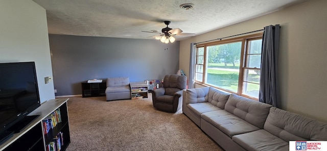 1241 Bessie St, Goehner, NE 68364 - living area featuring carpet, a ceiling fan, a textured ceiling, and baseboards