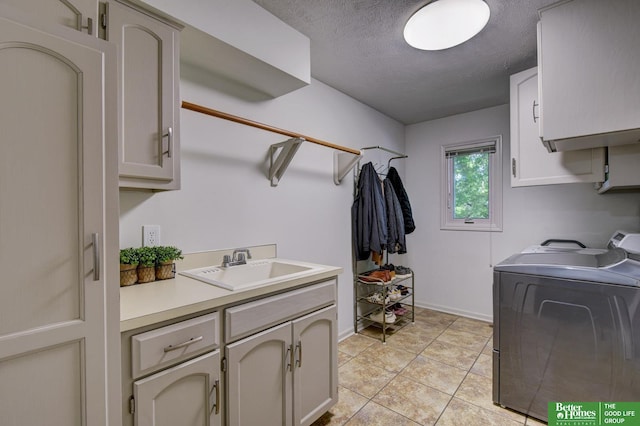 1014 Hickory Hill Rd, Papillion, NE 68046 - washroom with cabinet space, washer and clothes dryer, a textured ceiling, and baseboards