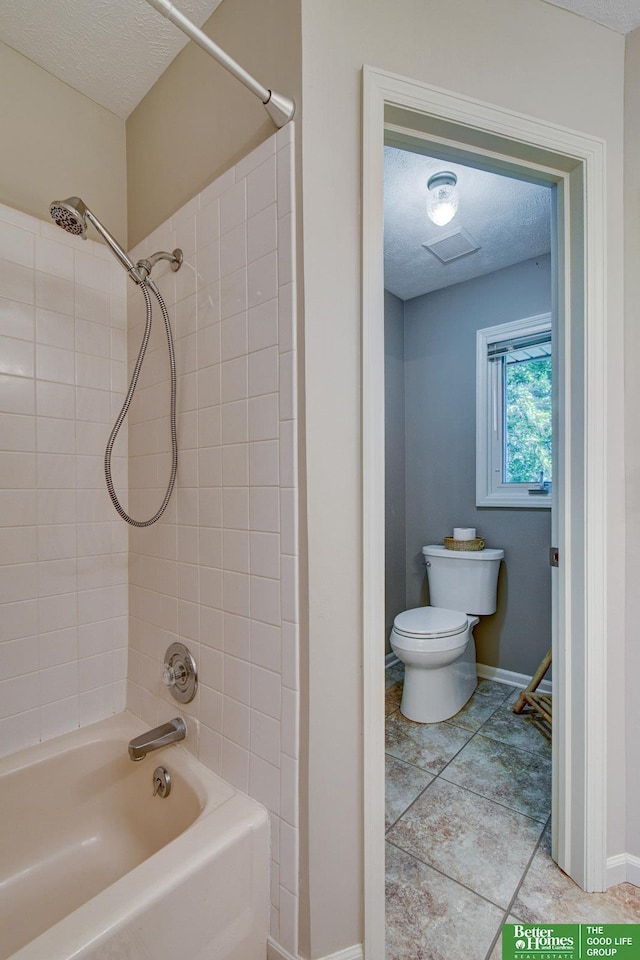 1014 Hickory Hill Rd, Papillion, NE 68046 - bathroom with toilet, washtub / shower combination, a textured ceiling, and baseboards