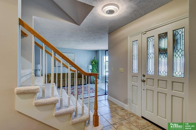 1014 Hickory Hill Rd, Papillion, NE 68046 - foyer entrance with a textured ceiling, stairway, tile patterned flooring, and baseboards