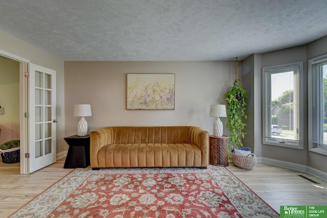 1014 Hickory Hill Rd, Papillion, NE 68046 - living area with wood finished floors, baseboards, and a textured ceiling