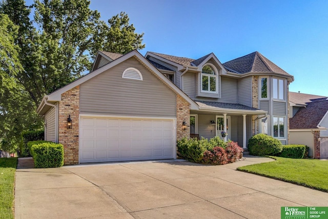 1014 Hickory Hill Rd, Papillion, NE 68046 - view of front of home featuring driveway, covered porch, an attached garage, a front yard, and roof with shingles