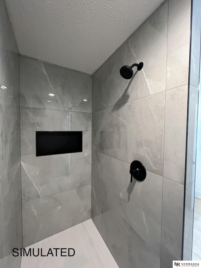 1231 SW 36th St, Lincoln, NE 68522 - full bathroom featuring a tile shower and a textured ceiling