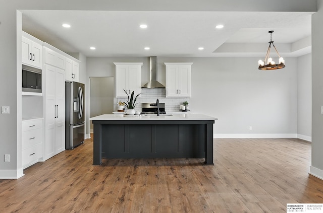 8218 N 167th Ave, Bennington, NE 68007 - kitchen featuring stainless steel appliances, wall chimney exhaust hood, baseboards, tasteful backsplash, and wood finished floors