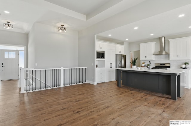 8218 N 167th Ave, Bennington, NE 68007 - kitchen with wall chimney range hood, stainless steel appliances, wood finished floors, tasteful backsplash, and recessed lighting
