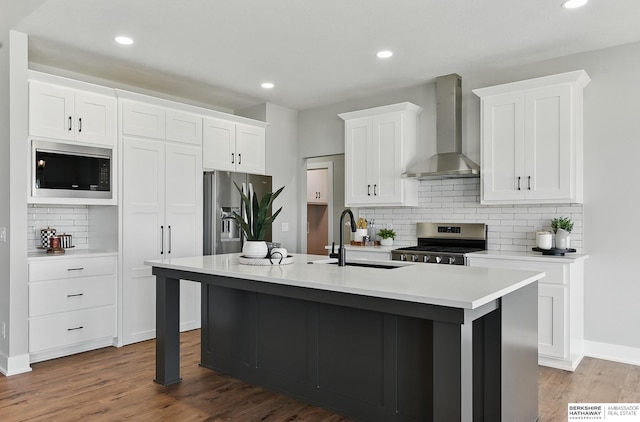 8218 N 167th Ave, Bennington, NE 68007 - kitchen with stainless steel appliances, wall chimney range hood, a sink, backsplash, and an island with sink
