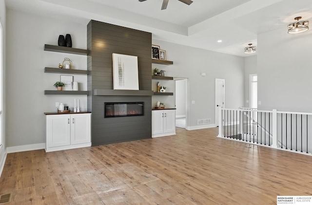 8218 N 167th Ave, Bennington, NE 68007 - unfurnished living room with light wood-style flooring, a fireplace, ceiling fan, baseboards, and recessed lighting