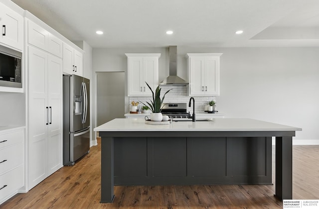 8218 N 167th Ave, Bennington, NE 68007 - kitchen featuring appliances with stainless steel finishes, wall chimney range hood, a sink, backsplash, and a kitchen island with sink