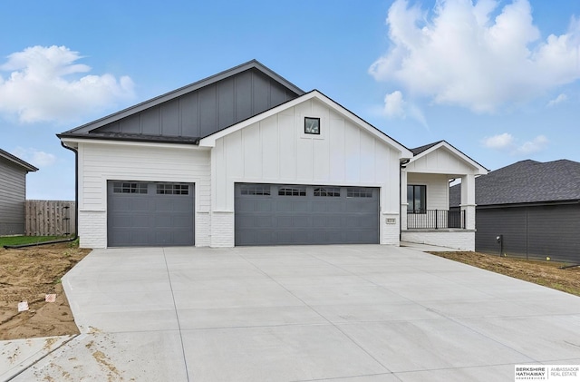 8218 N 167th Ave, Bennington, NE 68007 - view of front of home with an attached garage, concrete driveway, board and batten siding, covered porch, and brick siding