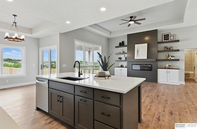 8218 N 167th Ave, Bennington, NE 68007 - kitchen with a tray ceiling, a sink, open shelves, dishwasher, and a large fireplace