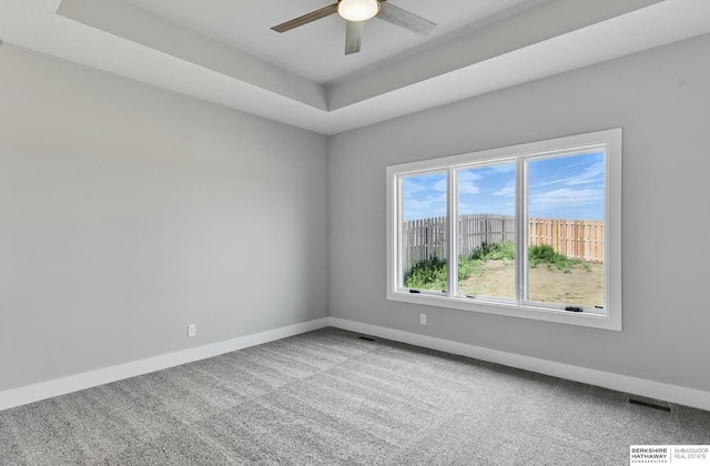 8218 N 167th Ave, Bennington, NE 68007 - carpeted spare room with a ceiling fan, baseboards, and a raised ceiling