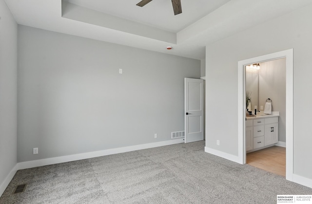 8218 N 167th Ave, Bennington, NE 68007 - unfurnished bedroom with light carpet, baseboards, and a tray ceiling