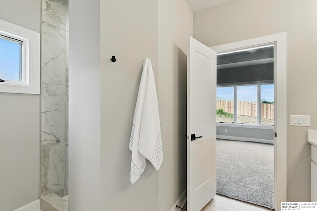8218 N 167th Ave, Bennington, NE 68007 - bathroom with a marble finish shower, baseboards, and vanity