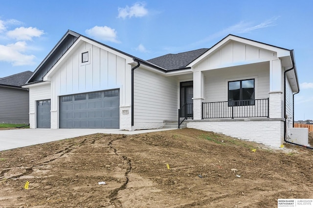 8218 N 167th Ave, Bennington, NE 68007 - view of front facade featuring board and batten siding, a garage, covered porch, driveway, and roof with shingles