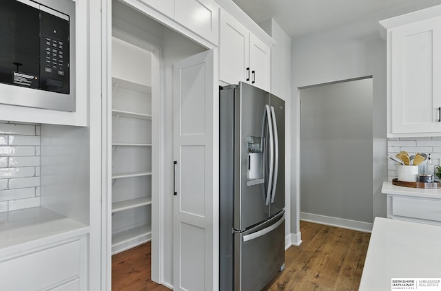 8218 N 167th Ave, Bennington, NE 68007 - kitchen featuring stainless steel refrigerator with ice dispenser, decorative backsplash, dark wood-style floors, white cabinetry, and light countertops