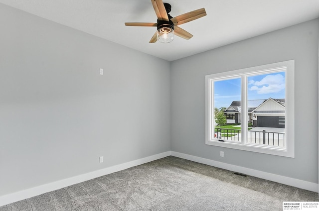 8218 N 167th Ave, Bennington, NE 68007 - spare room with baseboards, carpet flooring, and a ceiling fan
