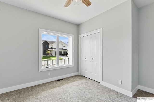 8218 N 167th Ave, Bennington, NE 68007 - unfurnished bedroom featuring carpet floors, baseboards, a closet, and a ceiling fan