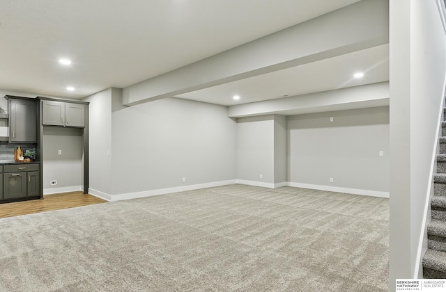 8218 N 167th Ave, Bennington, NE 68007 - finished below grade area with light colored carpet, stairway, recessed lighting, bar area, and baseboards