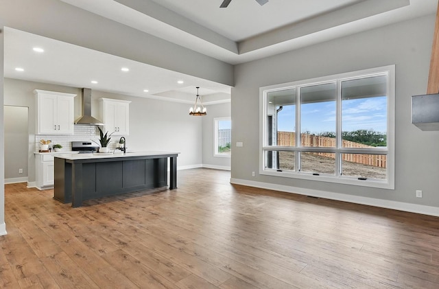 8218 N 167th Ave, Bennington, NE 68007 - kitchen with wall chimney exhaust hood, stainless steel range with electric cooktop, a raised ceiling, white cabinets, and recessed lighting