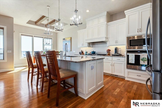 12601 S 78th St, Papillion, NE 68046 - kitchen featuring appliances with stainless steel finishes, a chandelier, white cabinets, stone countertops, and recessed lighting