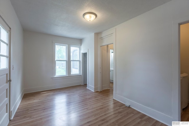 425 W Eagle St, Arlington, NE 68002 - unfurnished bedroom featuring light wood-type flooring, baseboards, and a textured ceiling