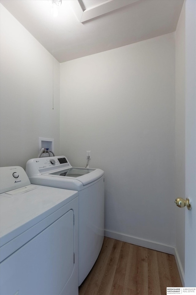 425 W Eagle St, Arlington, NE 68002 - laundry room with washing machine and clothes dryer, light wood-style floors, and baseboards
