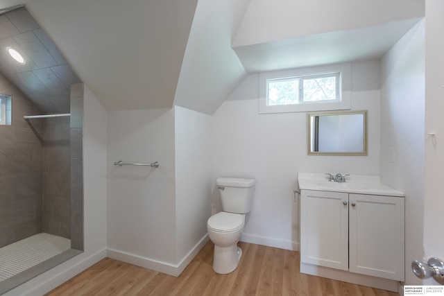 425 W Eagle St, Arlington, NE 68002 - bathroom with vaulted ceiling, toilet, vanity, wood finished floors, and tiled shower