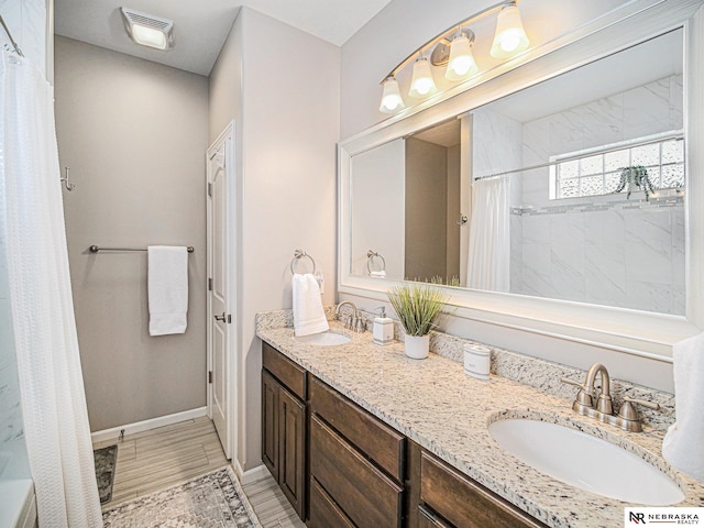 9656 White Pine Rd, Lincoln, NE 68505 - full bath featuring double vanity, curtained shower, and baseboards