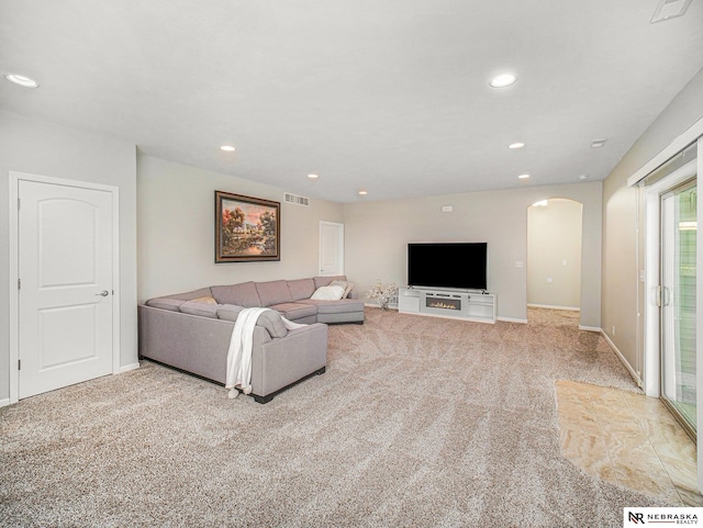 9656 White Pine Rd, Lincoln, NE 68505 - carpeted living area featuring arched walkways, baseboards, and recessed lighting