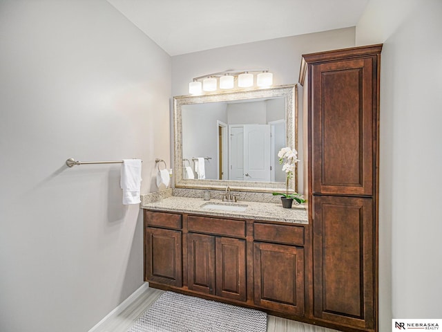 9656 White Pine Rd, Lincoln, NE 68505 - bathroom with vanity, baseboards, and wood finished floors