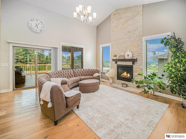 9656 White Pine Rd, Lincoln, NE 68505 - living room with high vaulted ceiling, a chandelier, light wood finished floors, a fireplace, and plenty of natural light