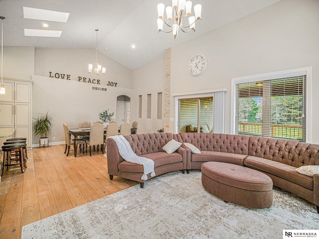 9656 White Pine Rd, Lincoln, NE 68505 - living area featuring a chandelier, high vaulted ceiling, light wood-style floors, and a skylight