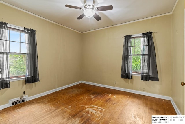 5101 Maple St, Omaha, NE 68104 - spare room featuring crown molding, wood finished floors, baseboards, and ceiling fan