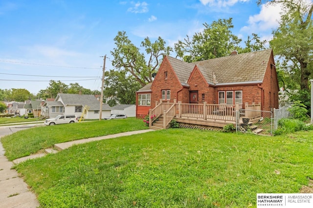 5101 Maple St, Omaha, NE 68104 - view of front facade featuring brick siding, a chimney, a wooden deck, and a high end roof