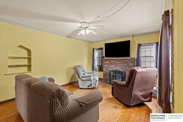 5101 Maple St, Omaha, NE 68104 - living room featuring healthy amount of natural light, wood finished floors, a fireplace, crown molding, and ceiling fan
