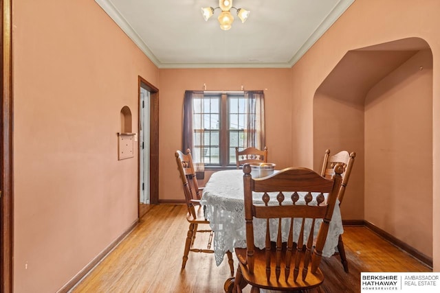 5101 Maple St, Omaha, NE 68104 - dining room with light wood-style flooring, ornamental molding, baseboards, and arched walkways