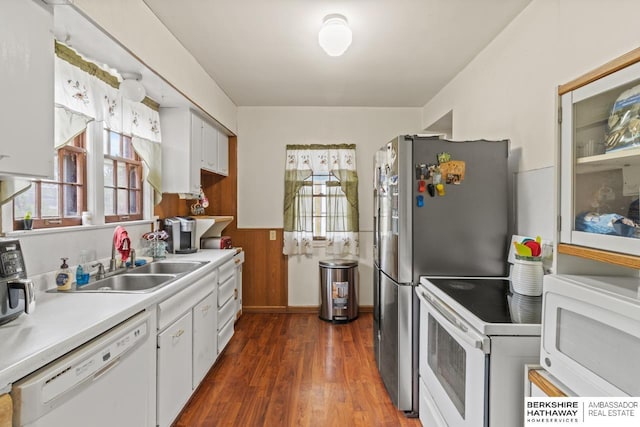 5101 Maple St, Omaha, NE 68104 - kitchen featuring white appliances, plenty of natural light, a wainscoted wall, white cabinetry, and wood walls