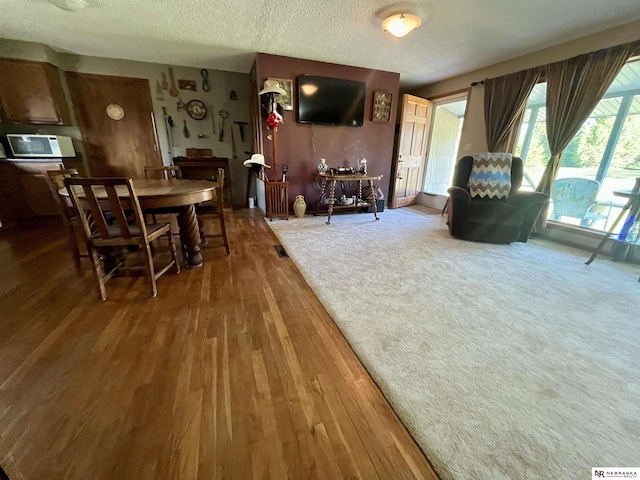 606 E 7th St, Valentine, NE 69201 - dining room featuring wood finished floors and a textured ceiling