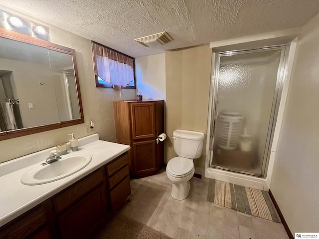 606 E 7th St, Valentine, NE 69201 - full bathroom featuring a stall shower, vanity, toilet, and a textured ceiling