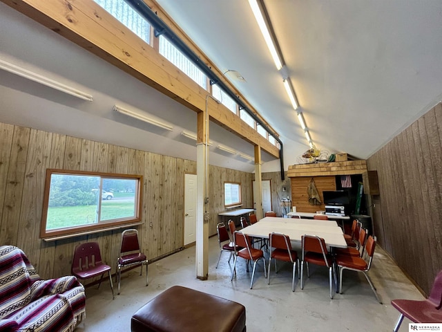 606 E 7th St, Valentine, NE 69201 - dining space featuring concrete floors, wooden walls, and vaulted ceiling