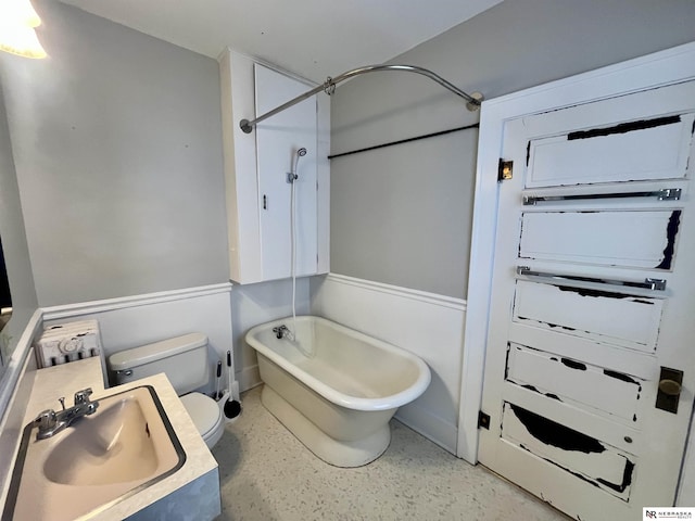 238 N Ray St, Valentine, NE 69201 - bathroom with a sink, toilet, shower / tub combination, and speckle patterned floor
