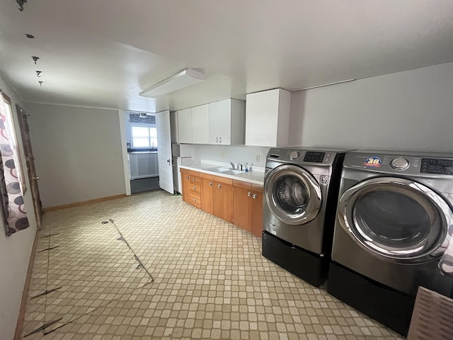 238 N Ray St, Valentine, NE 69201 - laundry room with independent washer and dryer, cabinet space, and baseboards