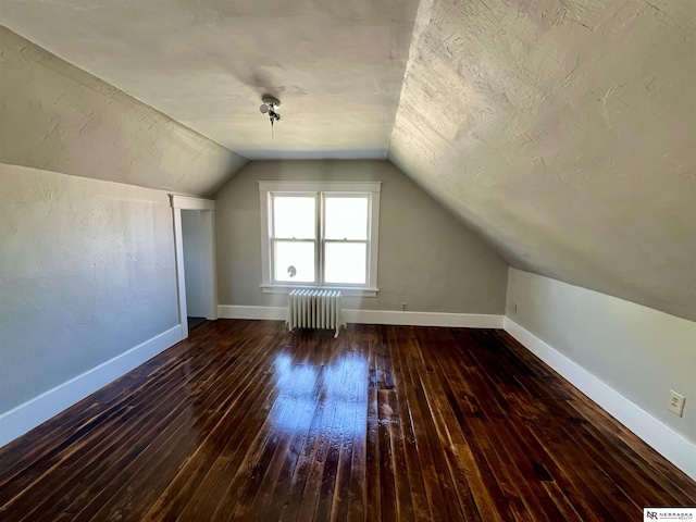 238 N Ray St, Valentine, NE 69201 - additional living space featuring radiator heating unit, wood-type flooring, lofted ceiling, and baseboards