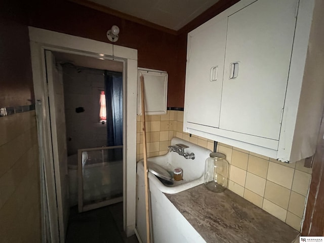 238 N Ray St, Valentine, NE 69201 - bathroom featuring tile walls and a sink