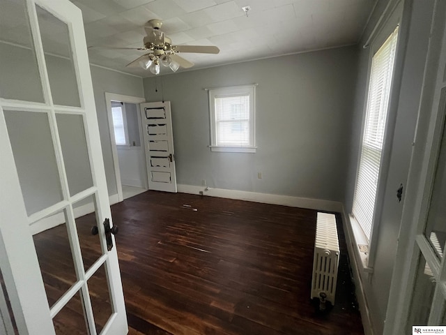 238 N Ray St, Valentine, NE 69201 - unfurnished room with hardwood / wood-style floors, radiator heating unit, a ceiling fan, and baseboards