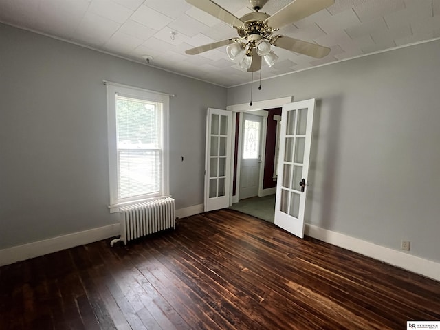 238 N Ray St, Valentine, NE 69201 - unfurnished room featuring radiator, french doors, hardwood / wood-style flooring, ceiling fan, and baseboards
