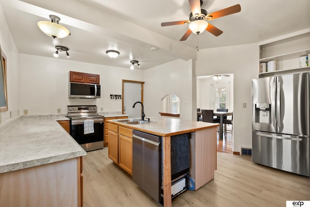 1346 G St, Pawnee City, NE 68420 - kitchen with stainless steel appliances, a sink, ceiling fan, and light wood-style flooring