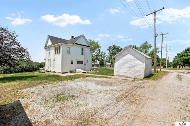 1346 G St, Pawnee City, NE 68420 - view of home's exterior featuring a chimney and a yard