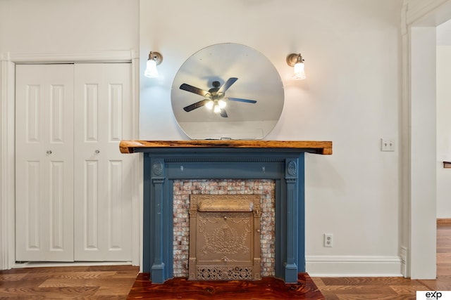 1346 G St, Pawnee City, NE 68420 - detailed view of ceiling fan, a fireplace with flush hearth, wood finished floors, and baseboards